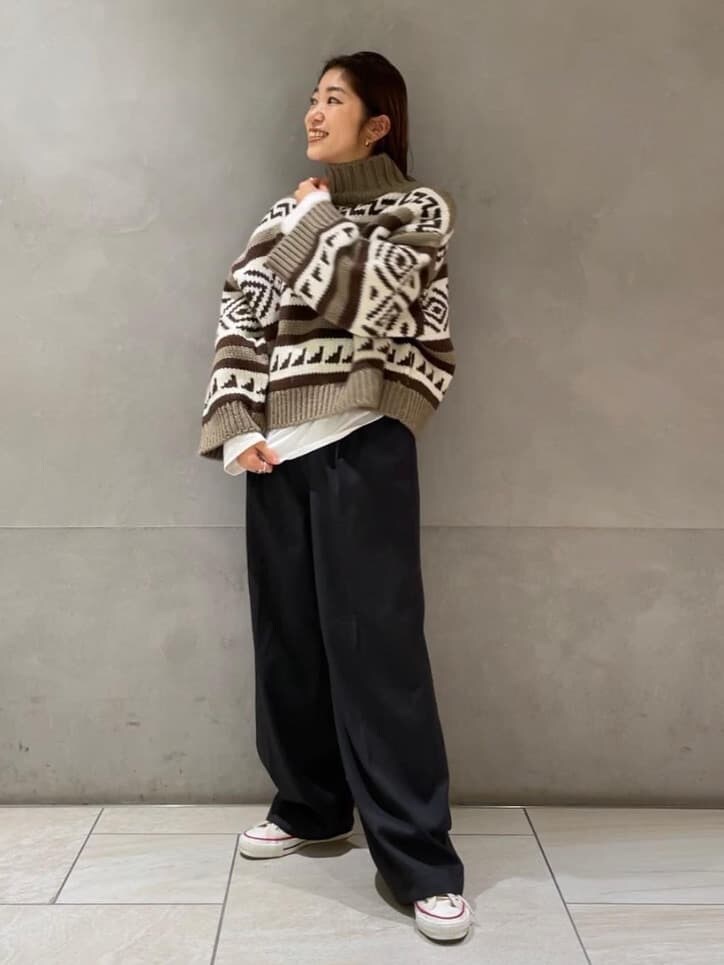 グレー系のその他パンツ、ベージュ系のニット/セーター、ホワイト系のTシャツ/カットソーを着用したレディースの冬コーディネートの4枚目の写真