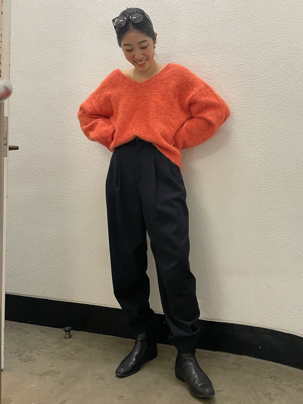 オレンジ系のニット/セーターを着用したレディースの冬コーディネートの4枚目の写真