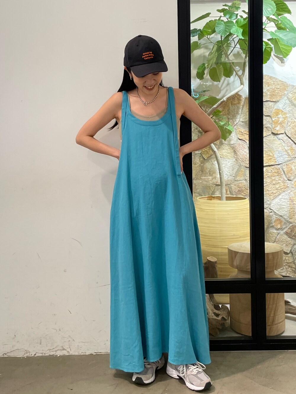 ブルー系のワンピース、グレー系のキャミソール、グレー系のキャップを着用したレディースの夏コーディネートの3枚目の写真