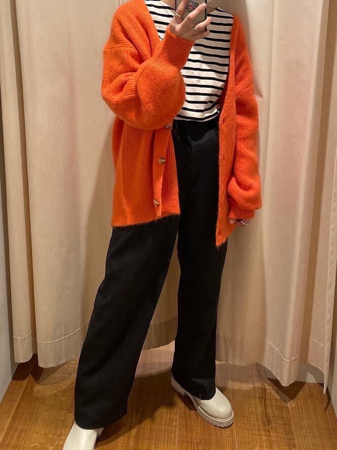 グレー系のその他パンツ、オレンジ系のカーディガン/ボレロを着用したレディースの冬コーディネートの3枚目の写真