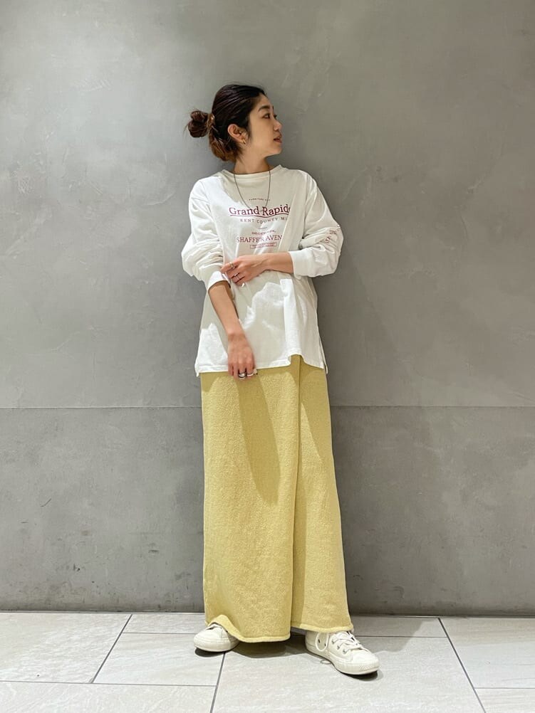 イエロー系のスカート、ホワイト系のTシャツ/カットソーを着用したレディースの冬コーディネートの3枚目の写真