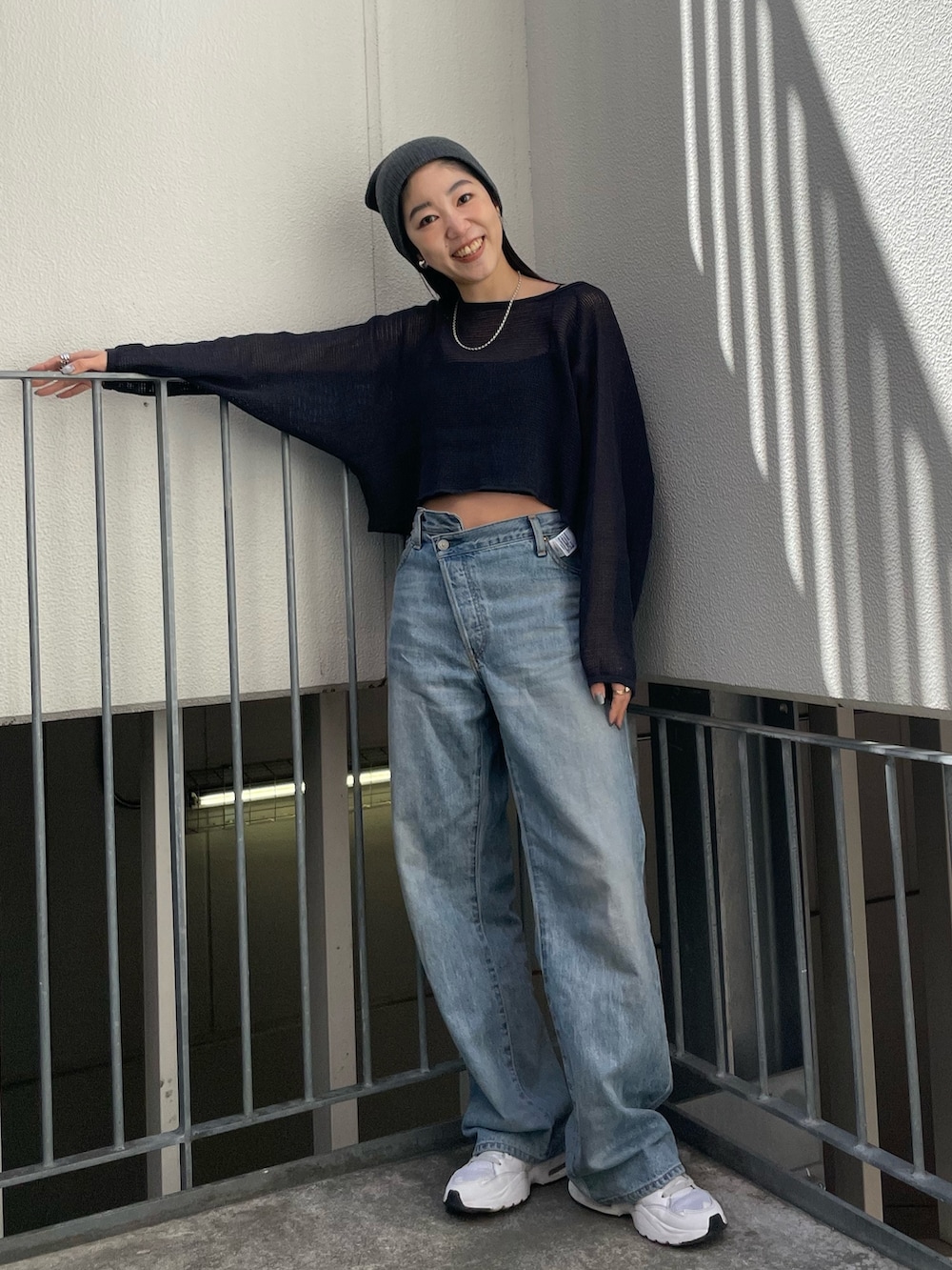 グレー系のTシャツ/カットソー、ブルー系のデニムパンツを着用したレディースの春コーディネートの3枚目の写真