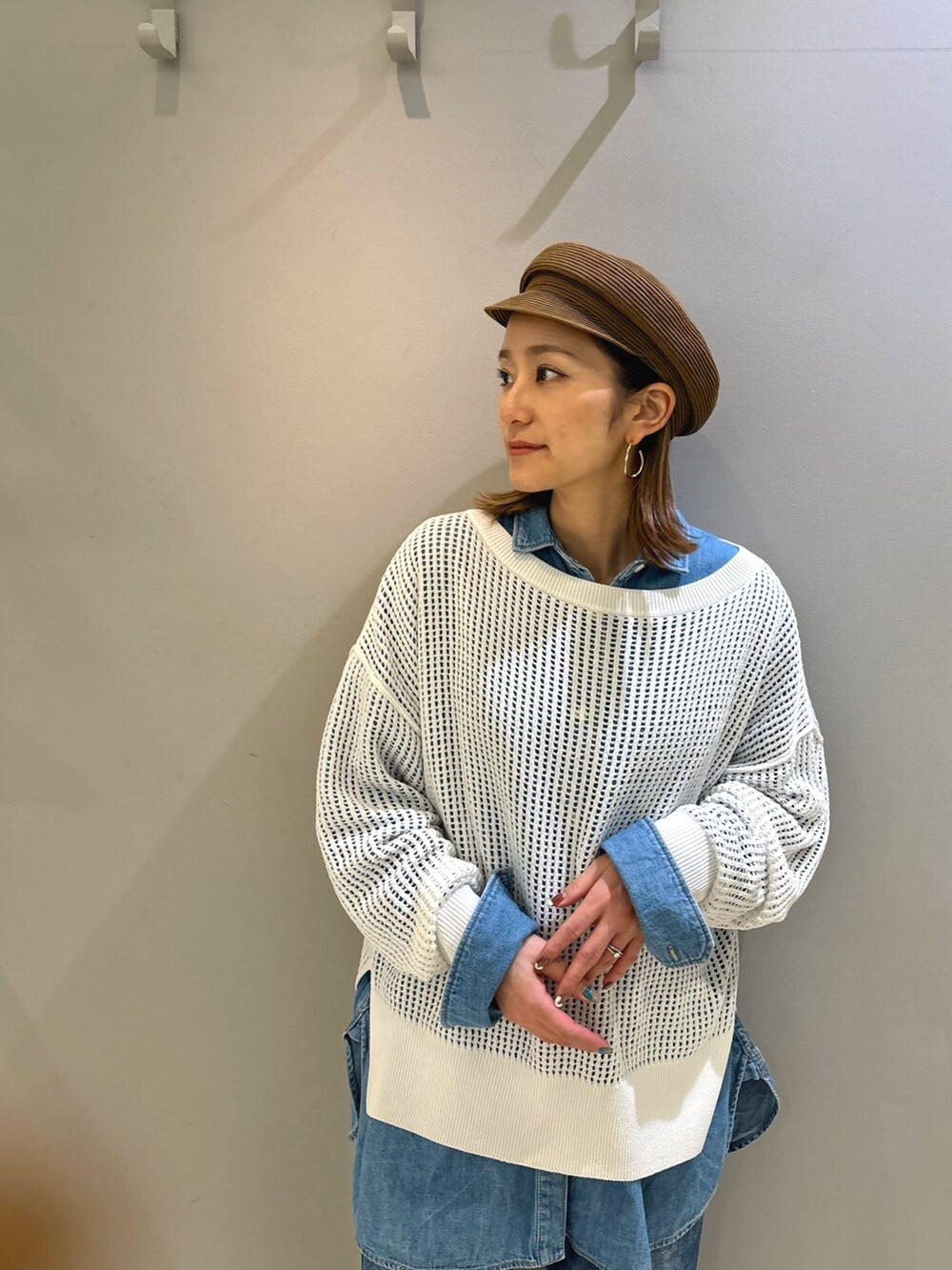 ホワイト系のニット/セーター、ブルー系のデニムパンツ、ブルー系のシャツ/ブラウスを着用したレディースの春コーディネートの3枚目の写真