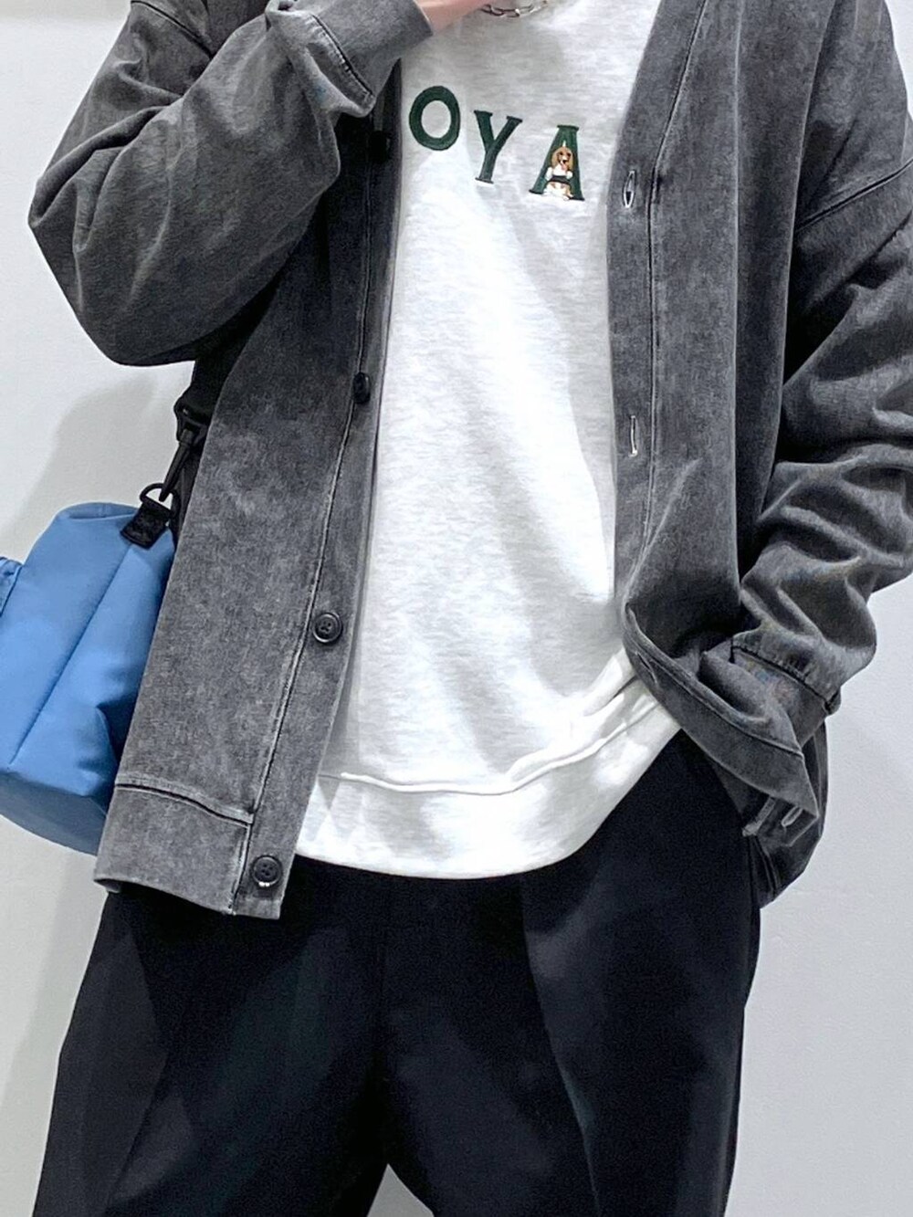 ブラック系のカーディガン/ボレロ、ブラック系のローファー、ブルー系のショルダーバッグを着用したメンズの春コーディネートの6枚目の写真