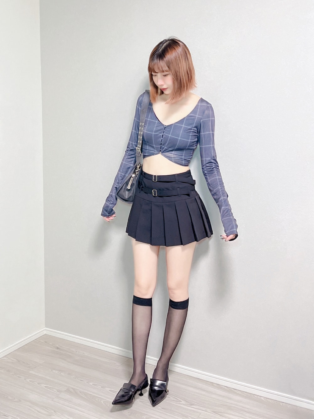 グレー系のシャツ/ブラウス、ブラック系のスカート、ブラック系のパンプスを着用したレディースの秋コーディネートの4枚目の写真