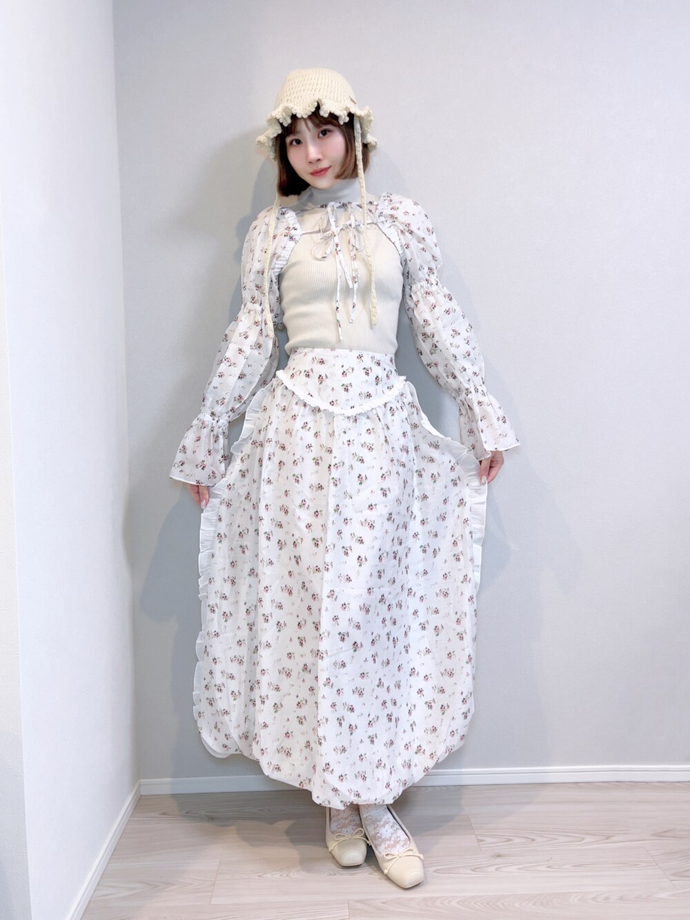 ホワイト系のスカート、ホワイト系のカーディガン/ボレロ、ホワイト系のニット/セーターを着用したレディースの春コーディネートの2枚目の写真