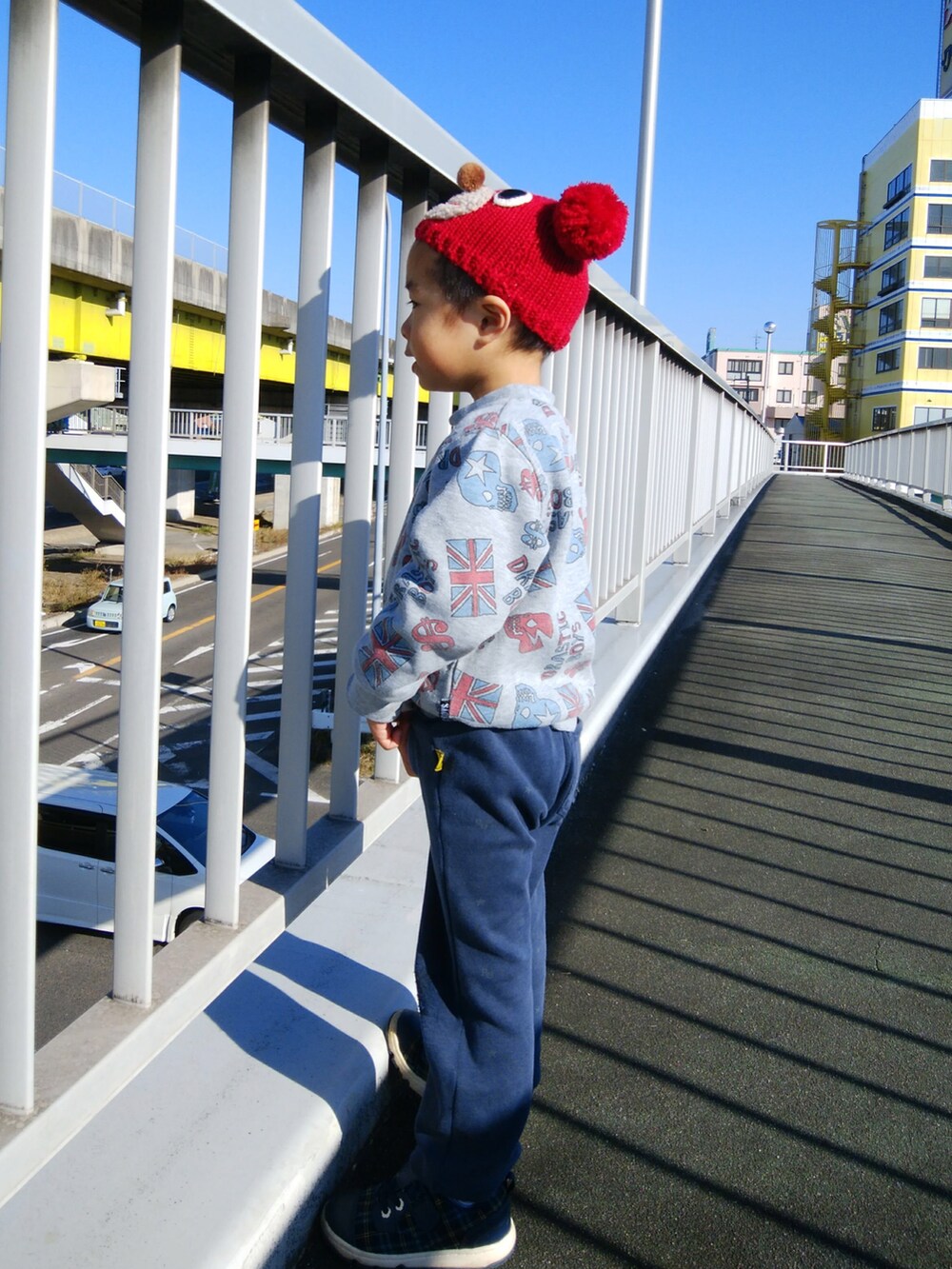 ブラック系のブルゾン、ブルー系のデニムパンツ、ベージュ系のパーカーを着用したメンズの冬コーディネートの2枚目の写真