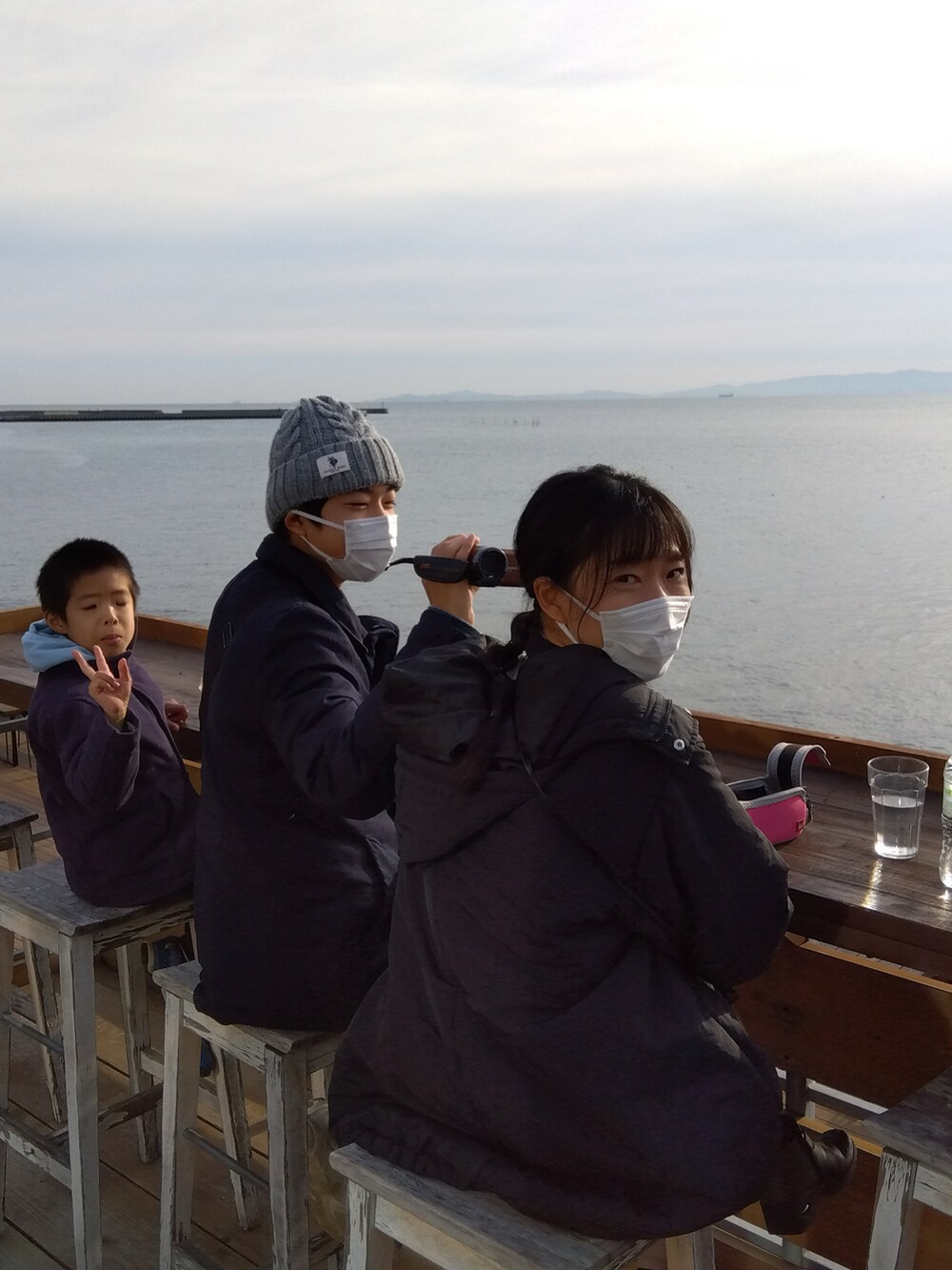 グリーン系のダウンジャケット/コート、ブルー系のデニムパンツ、ブラック系のキャップを着用したメンズの冬コーディネートの2枚目の写真