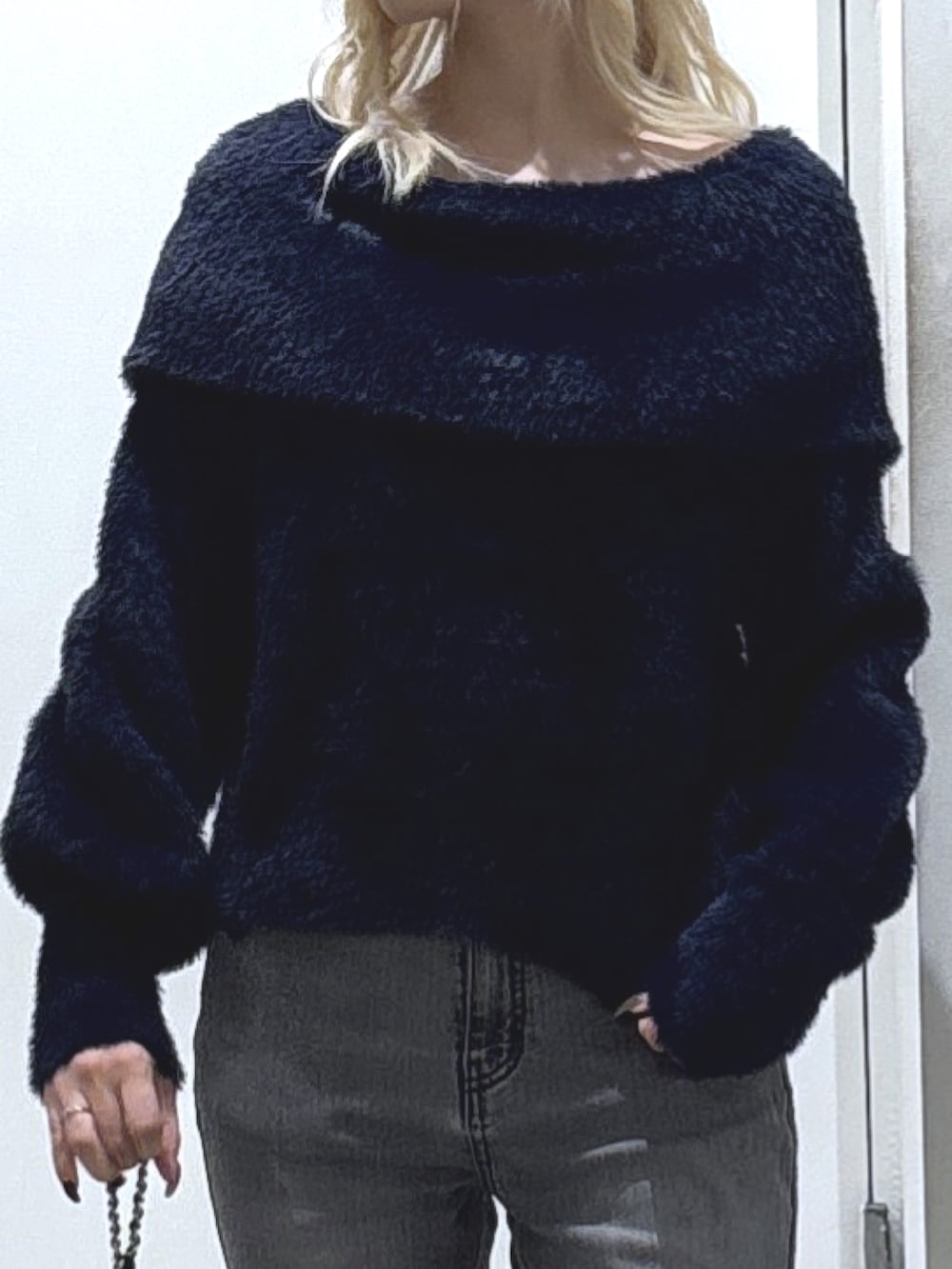 ブルー系のニット/セーター、ブラック系のデニムパンツ、ブラック系のトートバッグを着用したレディースの冬コーディネートの2枚目の写真