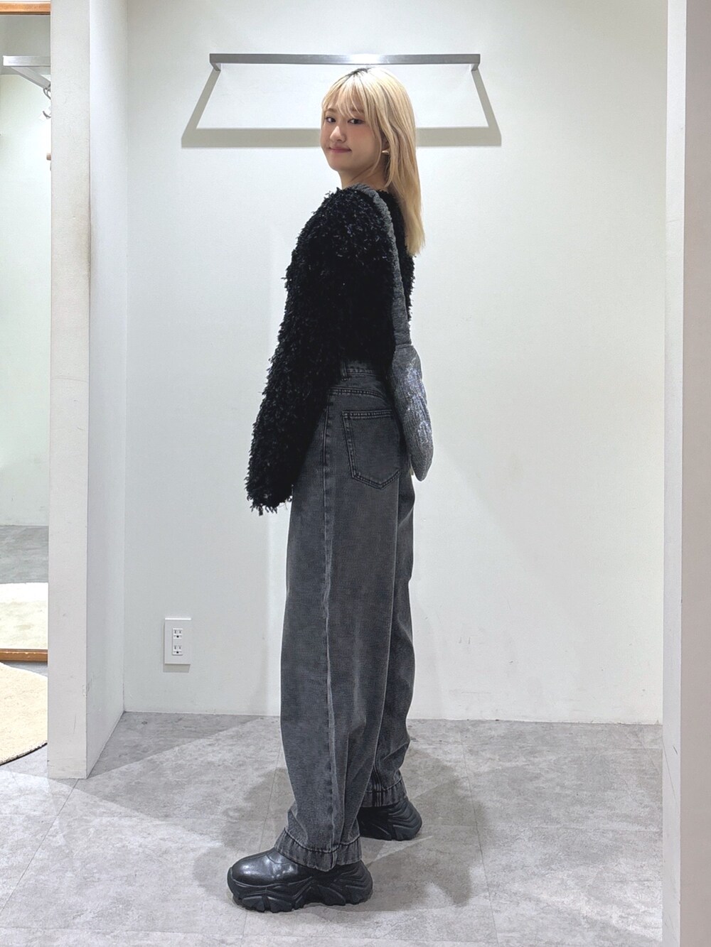 ブラック系のカーディガン/ボレロ、ブラック系のデニムパンツ、シルバー系のショルダーバッグを着用したレディースの秋コーディネートの3枚目の写真