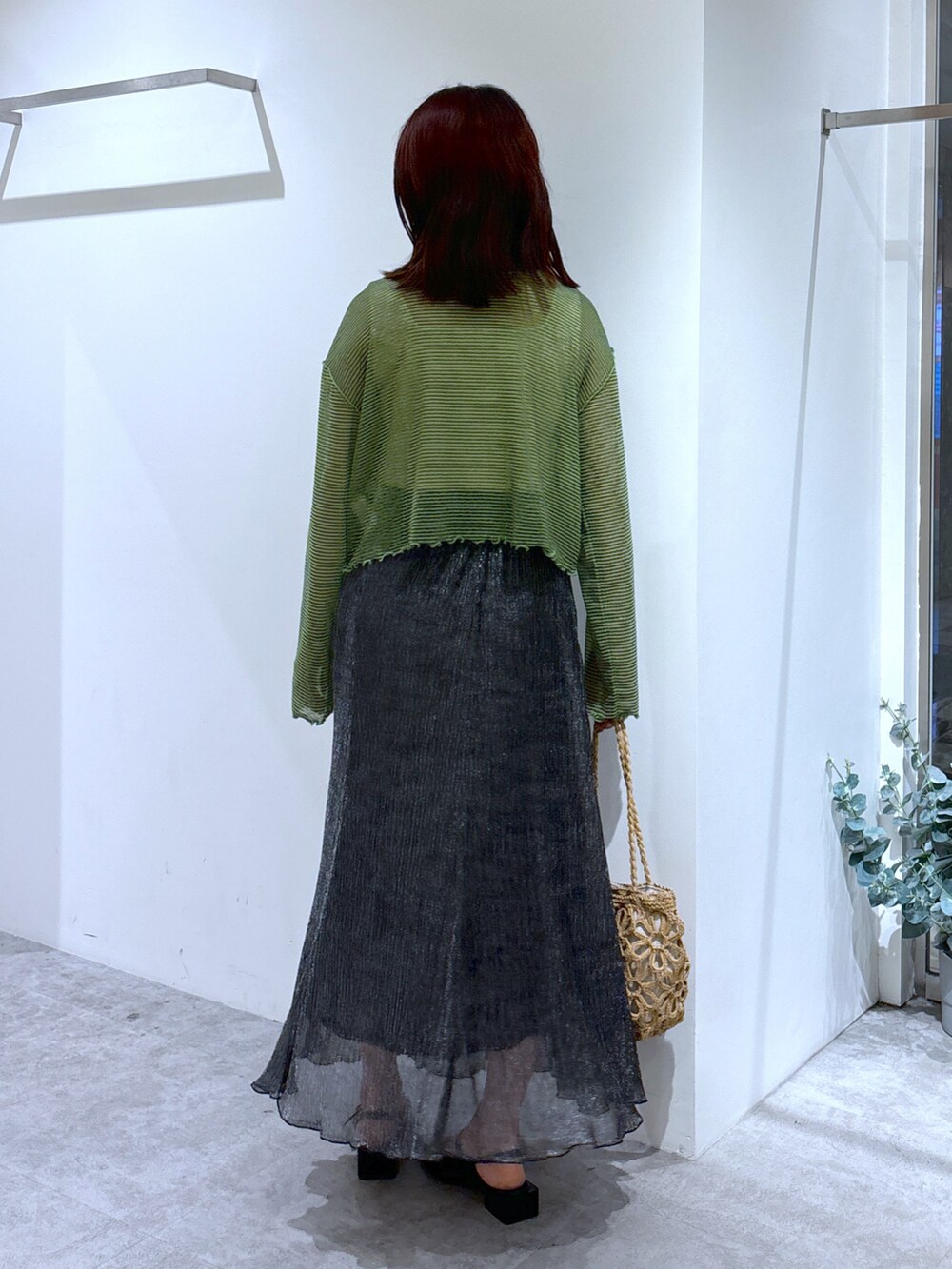 グレー系のカーディガン/ボレロ、ブラック系のスカート、ベージュ系のトートバッグを着用したレディースの夏コーディネートの3枚目の写真