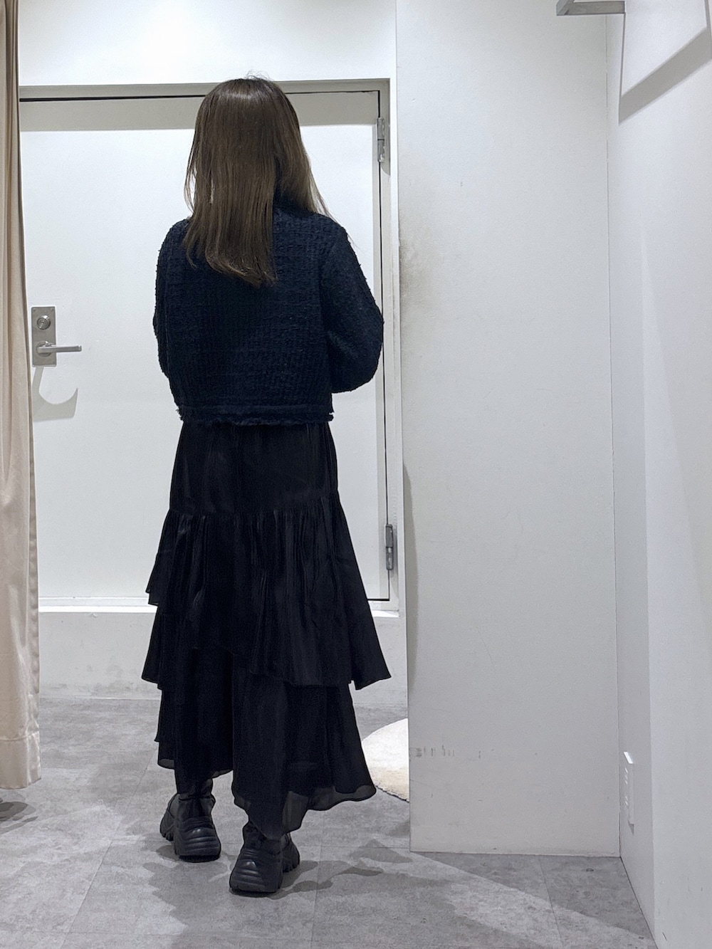 ブラック系のスカート、ブルー系のニット/セーターを着用したレディースの冬コーディネートの4枚目の写真