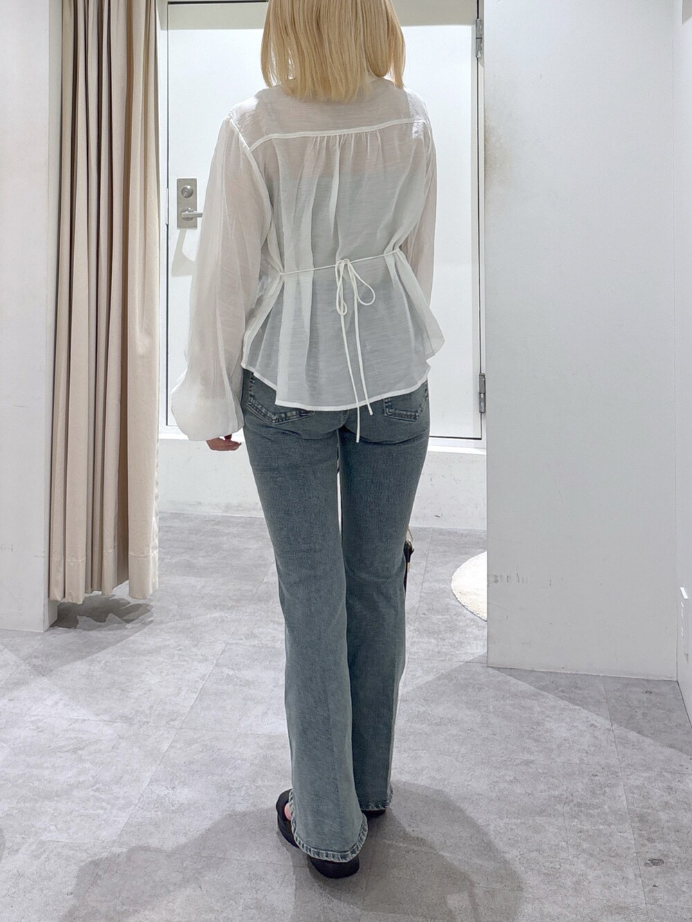 ホワイト系のシャツ/ブラウス、ブルー系のデニムパンツを着用したレディースの春コーディネートの4枚目の写真