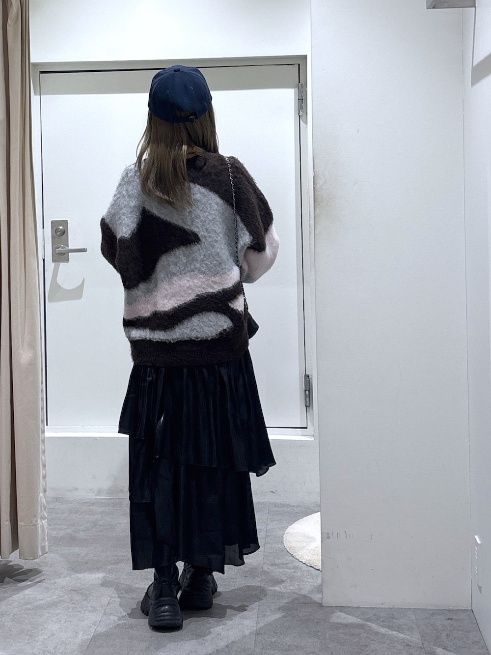 ブラック系のスカート、ブラウン系のニット/セーターを着用したレディースの冬コーディネートの5枚目の写真