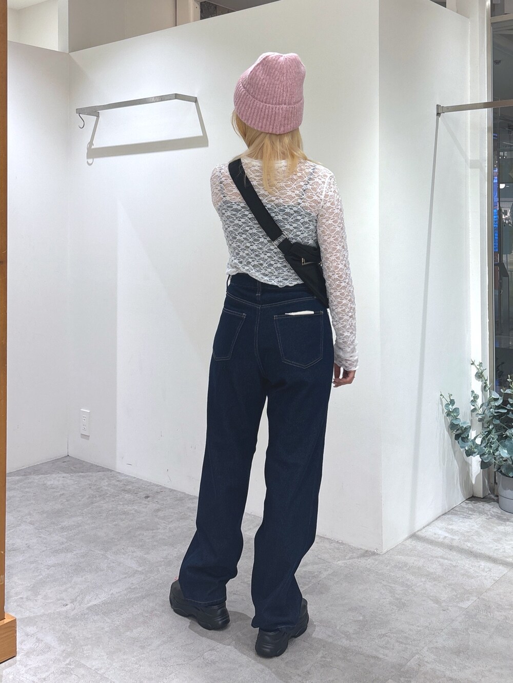 ホワイト系のTシャツ/カットソー、ブラック系のショルダーバッグ、ブルー系のデニムパンツを着用したレディースの秋コーディネートの4枚目の写真