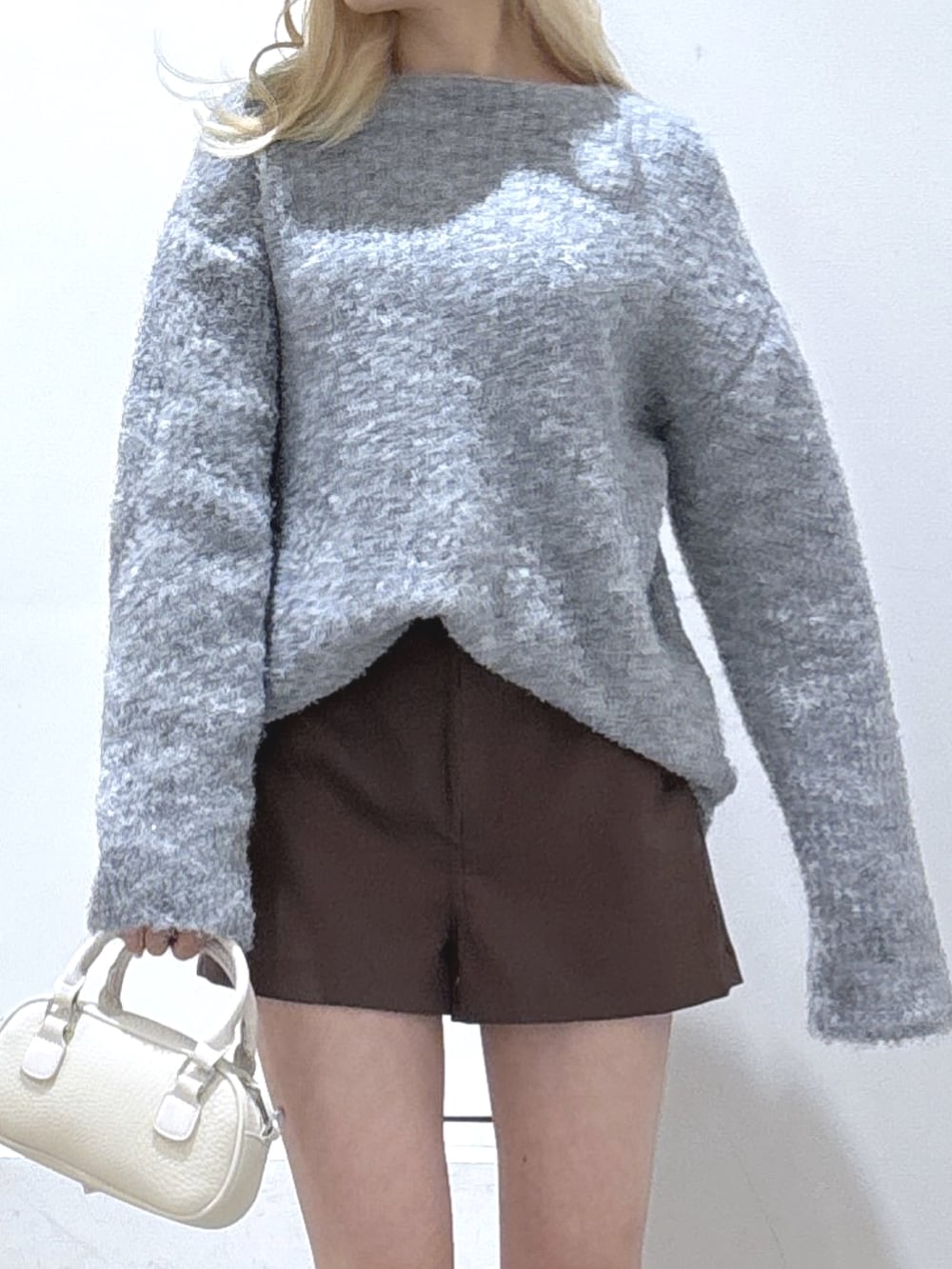 グレー系のニット/セーター、ブラウン系のその他パンツ、ブラウン系のブーツを着用したレディースの冬コーディネートの3枚目の写真