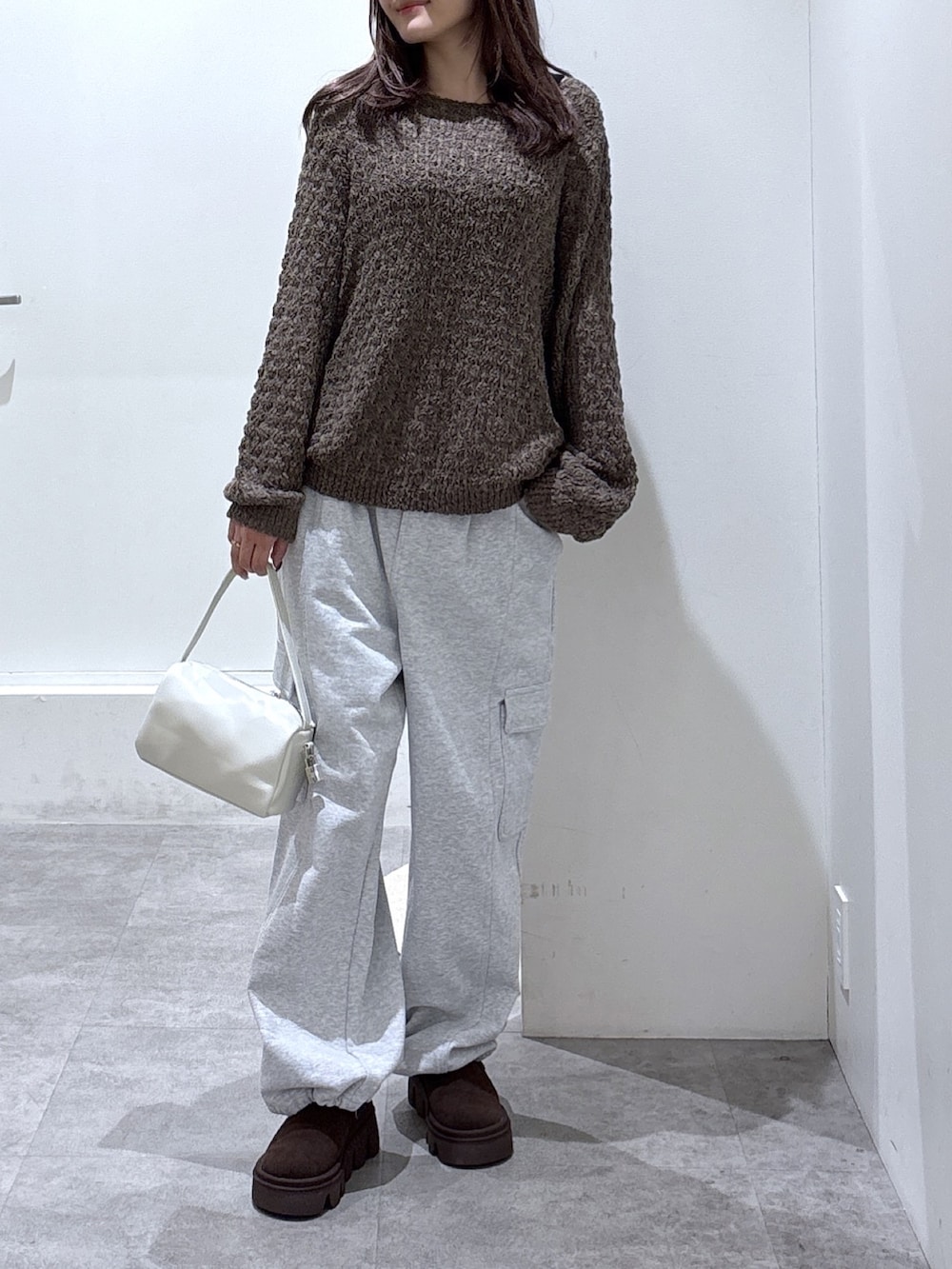 ブラウン系のニット/セーター、グレー系のその他パンツを着用したレディースの冬コーディネートの3枚目の写真