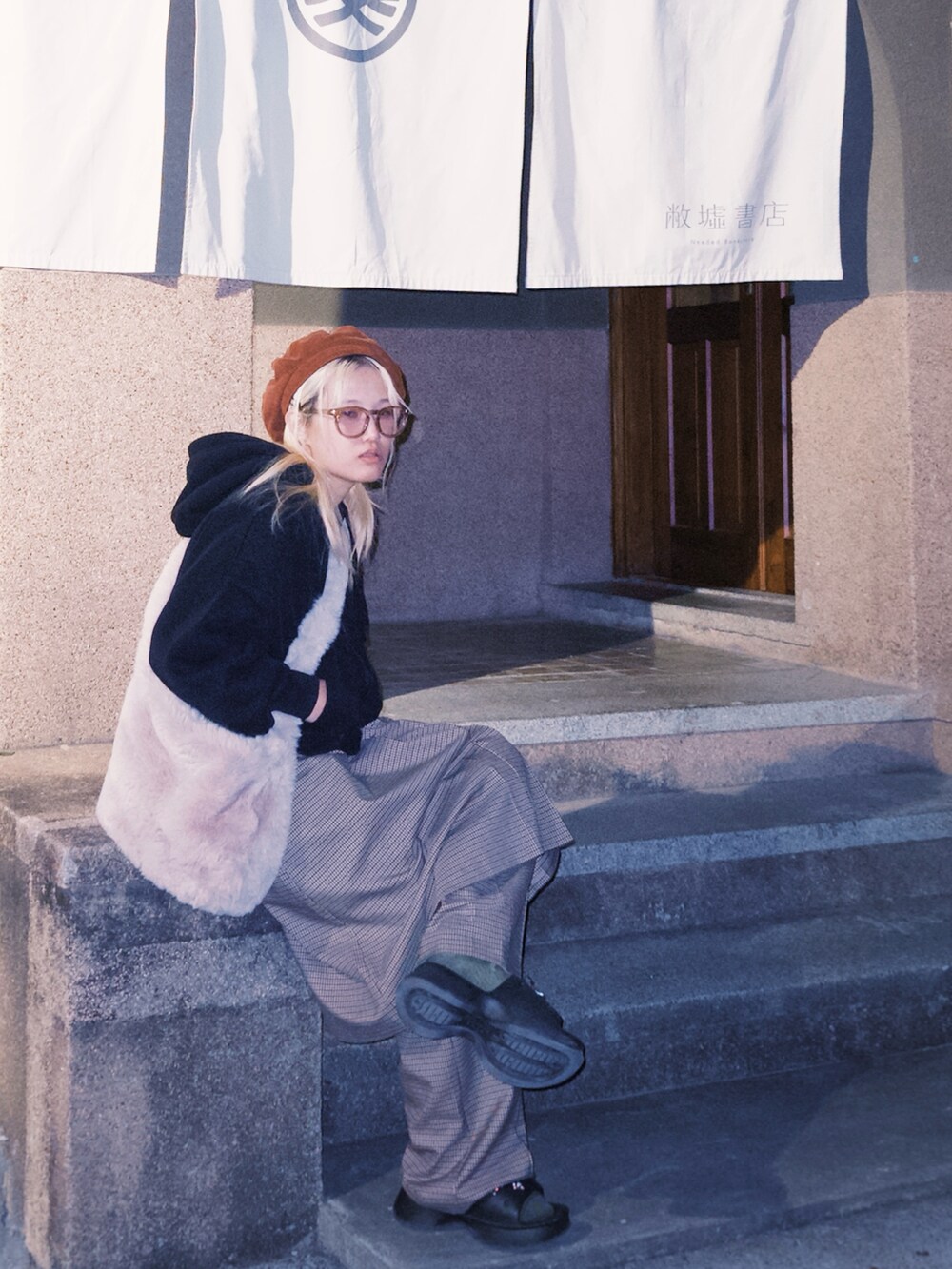 ブラック系のその他アウター、ベージュ系のスカート、ベージュ系のメガネを着用したレディースの冬コーディネートの2枚目の写真