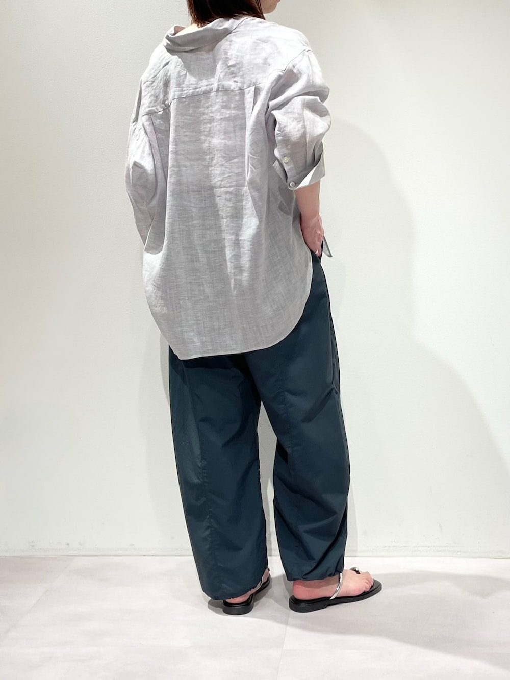 ホワイト系のニット/セーター、パープル系のシャツ/ブラウス、グレー系のその他パンツを着用したレディースの春コーディネートの3枚目の写真