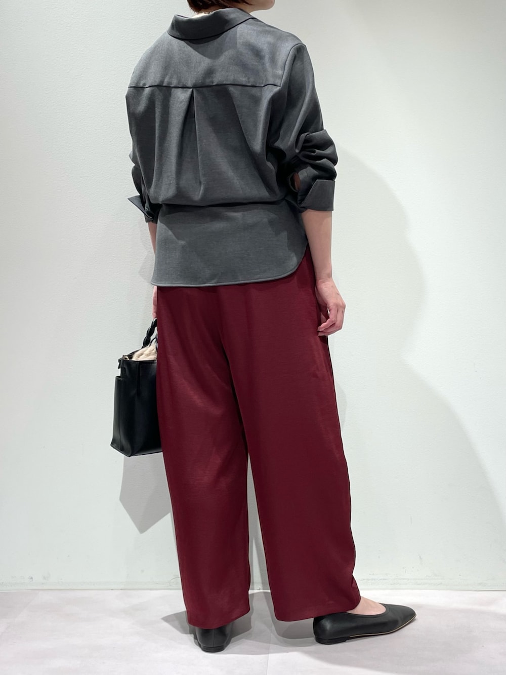 グレー系のシャツ/ブラウス、ブラック系のタンクトップ、レッド系のその他パンツを着用したレディースの秋コーディネートの2枚目の写真