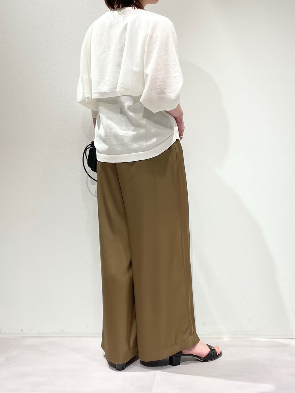 ホワイト系のニット/セーター、グリーン系のその他パンツ、ゴールド系のネックレスを着用したレディースの春コーディネートの3枚目の写真