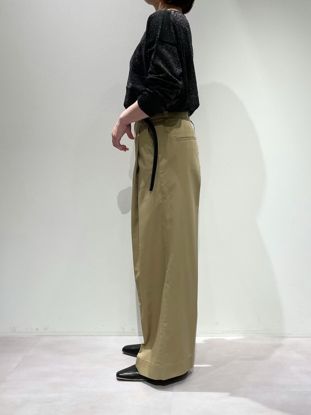 ブラック系のニット/セーター、ベージュ系のその他パンツ、ブラック系のパンプスを着用したレディースの夏コーディネートの2枚目の写真