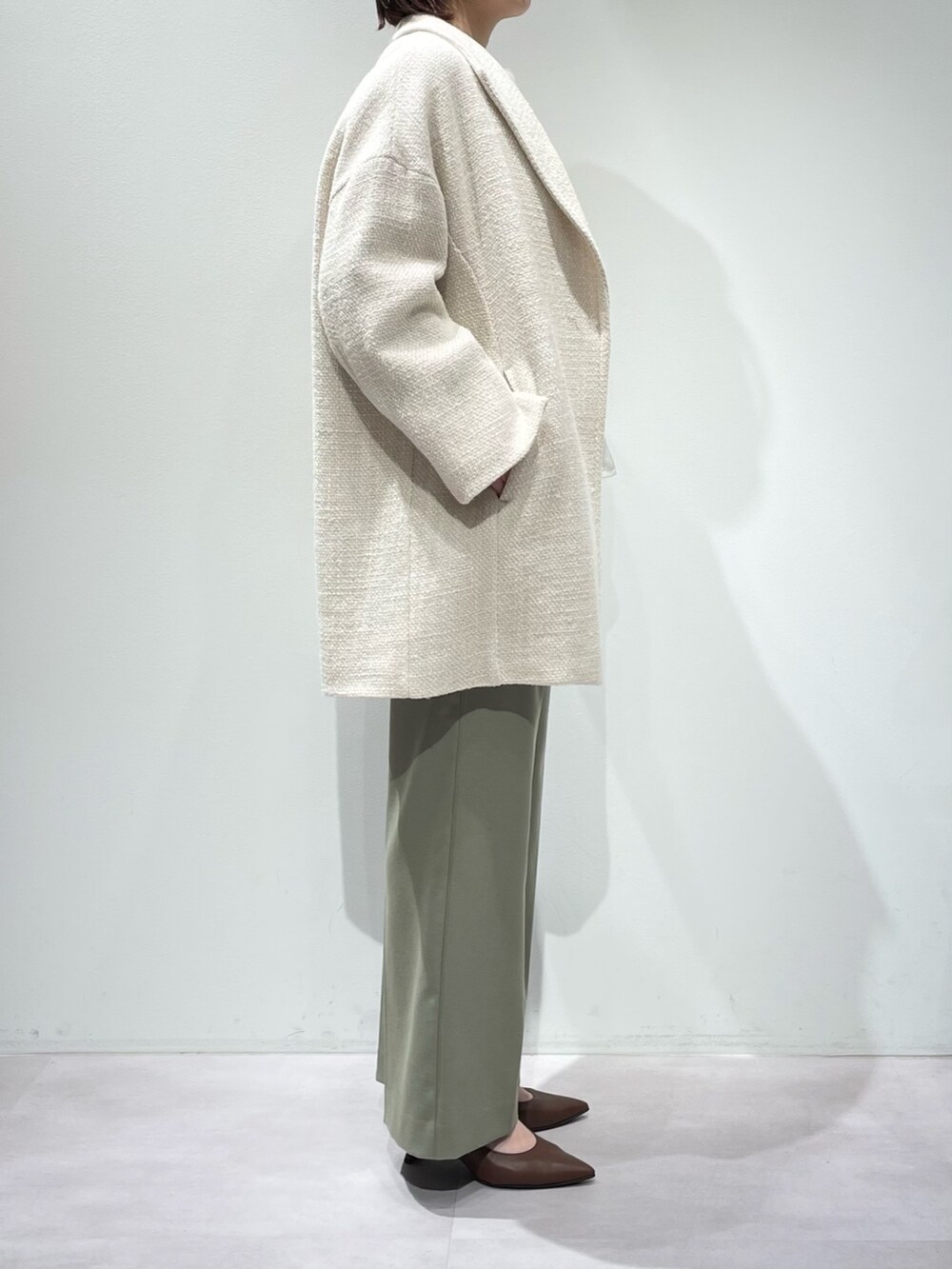 グリーン系のその他パンツ、ホワイト系のニット/セーター、ホワイト系のタンクトップを着用したレディースの冬コーディネートの2枚目の写真