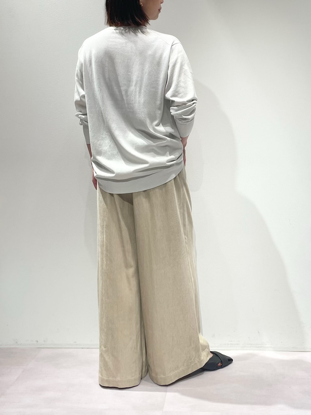 ベージュ系のその他パンツ、ホワイト系のニット/セーター、シルバー系のネックレスを着用したレディースの秋コーディネートの2枚目の写真