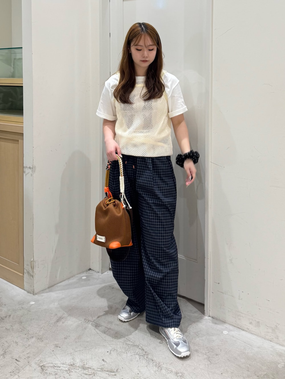 ブルー系のその他パンツ、イエロー系のショルダーバッグ、ホワイト系のタンクトップを着用したレディースの夏コーディネートの2枚目の写真