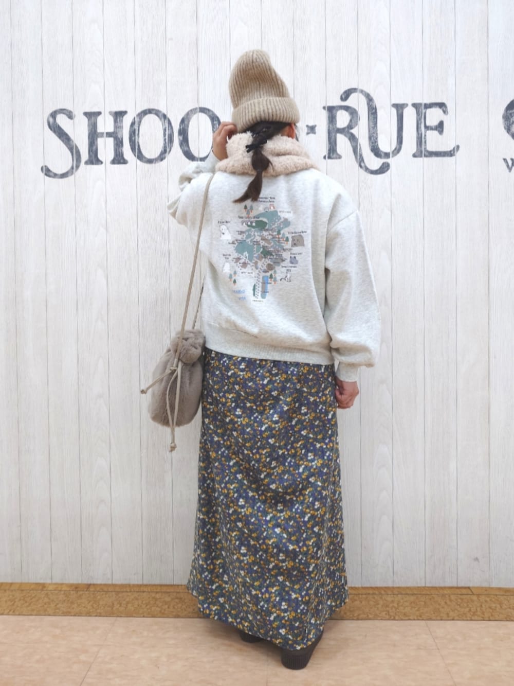 ホワイト系のスウェット、ブラウン系のショルダーバッグ、ブラウン系のブーツを着用したレディースの秋コーディネートの3枚目の写真