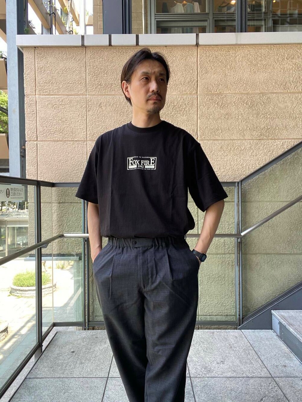 ブラック系のサンダル、グレー系のその他パンツ、ブラック系のTシャツ/カットソーを着用したメンズの夏コーディネートの2枚目の写真