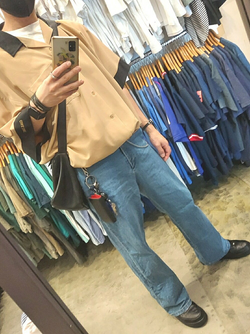 ブルー系のデニムパンツ、ブラック系のスニーカー、ベージュ系のシャツ/ブラウスを着用したメンズの春コーディネートの5枚目の写真