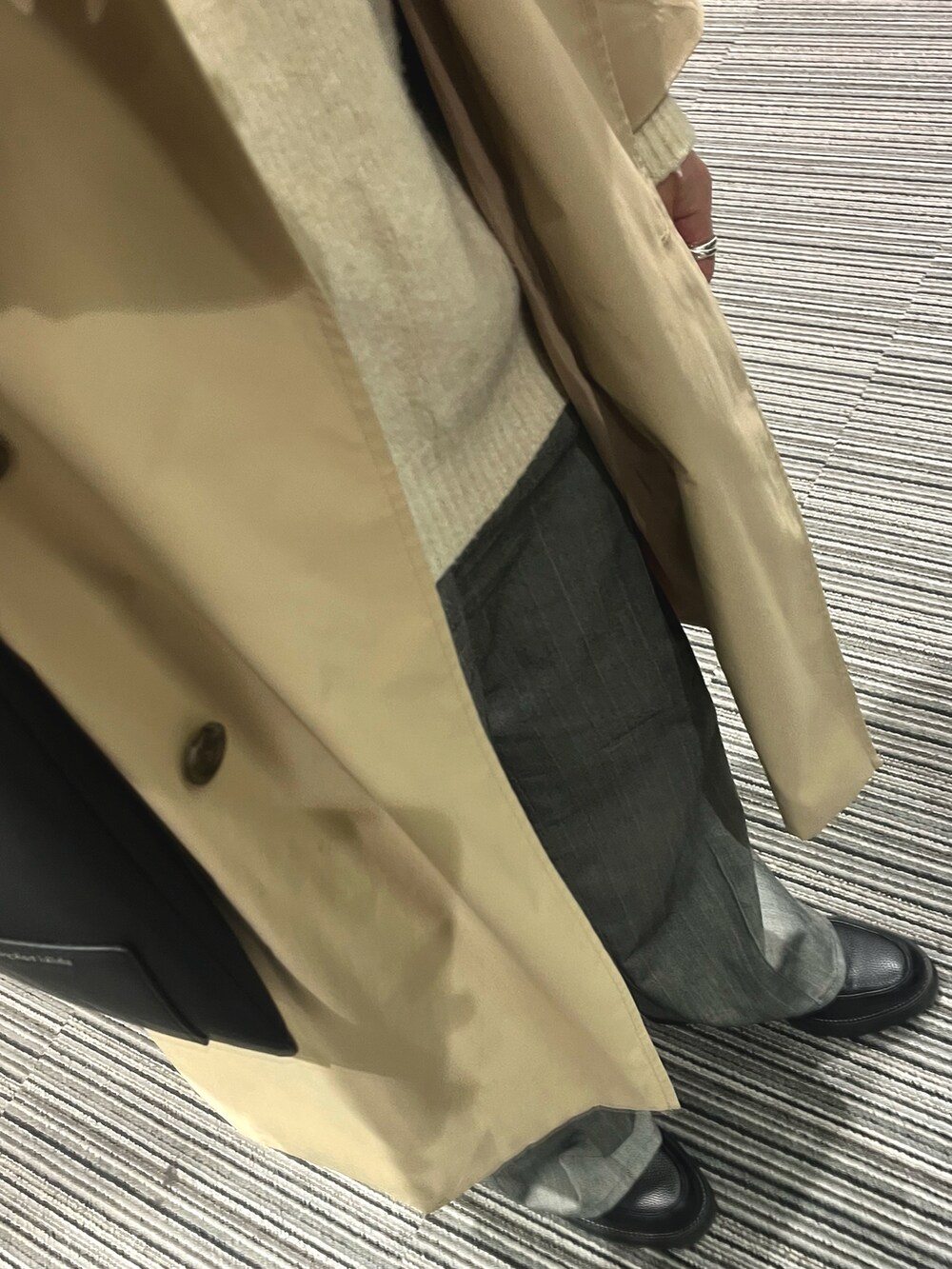 ブラック系のドレスシューズ、グレー系のスラックス、ホワイト系のニット/セーターを着用したメンズの春コーディネートの3枚目の写真