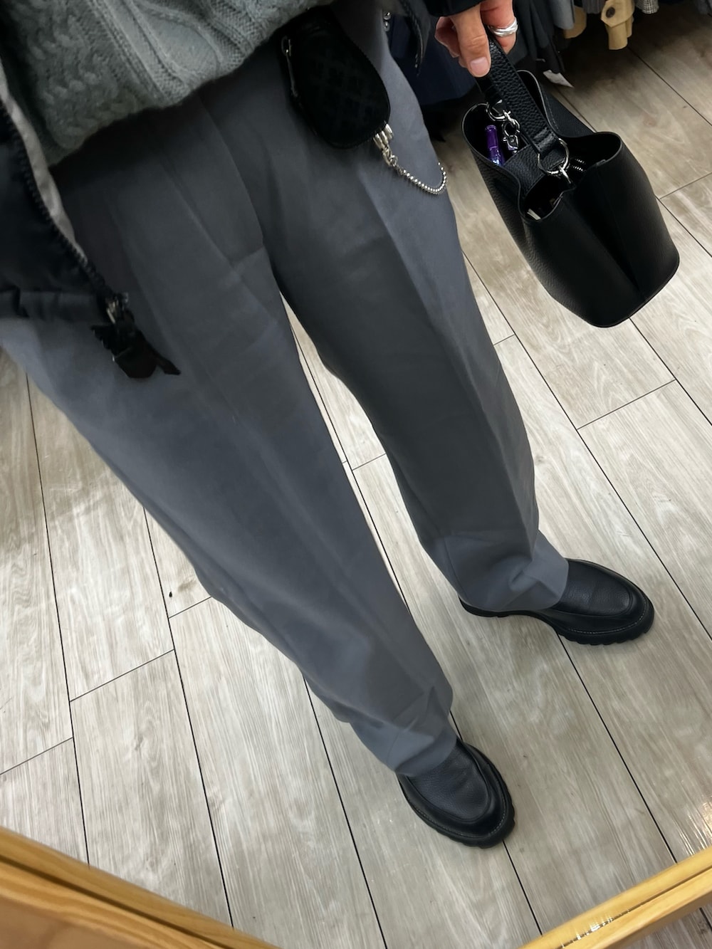 ブラック系のダウンジャケット/コート、ブラック系のショルダーバッグ、ブラック系のドレスシューズを着用したメンズの冬コーディネートの3枚目の写真