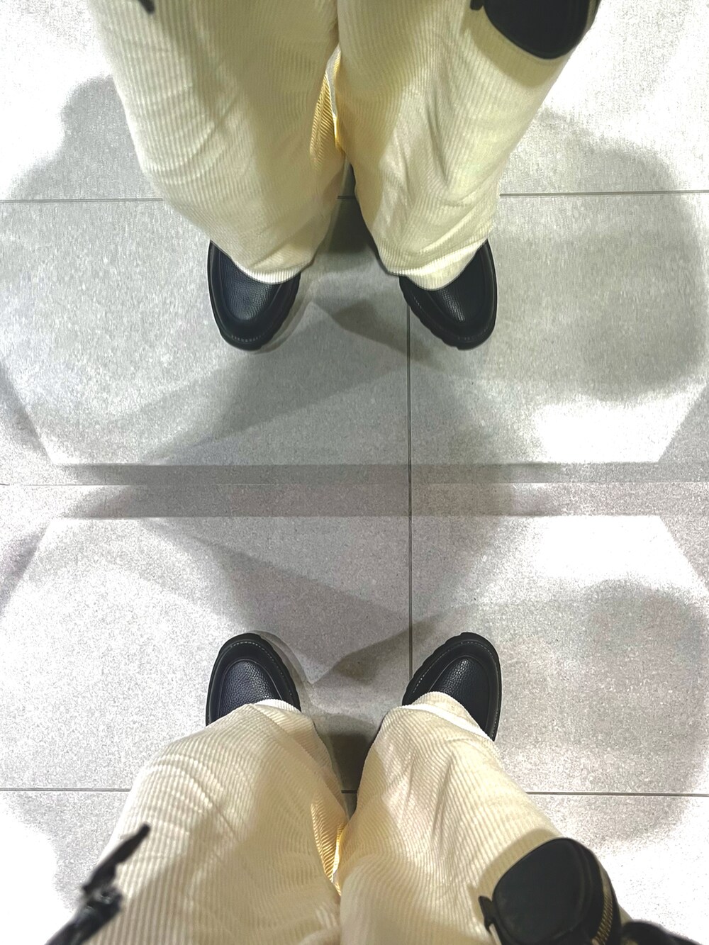 ブラック系のドレスシューズ、ホワイト系のパンツ、その他のニット/セーターを着用したメンズの春コーディネートの5枚目の写真