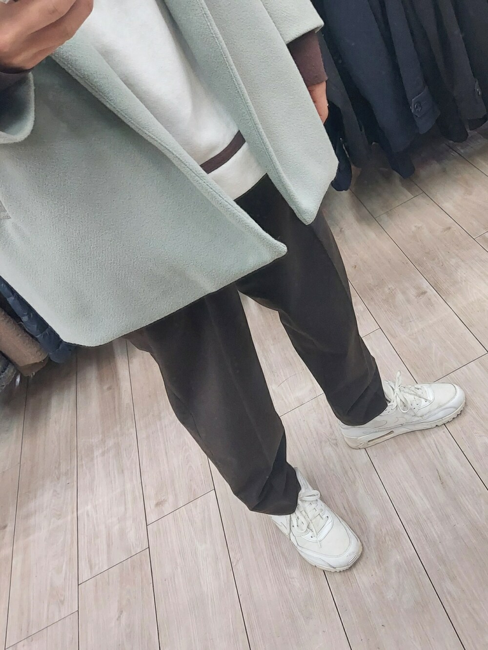 ブラウン系のパンツ、グリーン系のジャケット/アウター、ホワイト系のスニーカーを着用したメンズの冬コーディネートの3枚目の写真