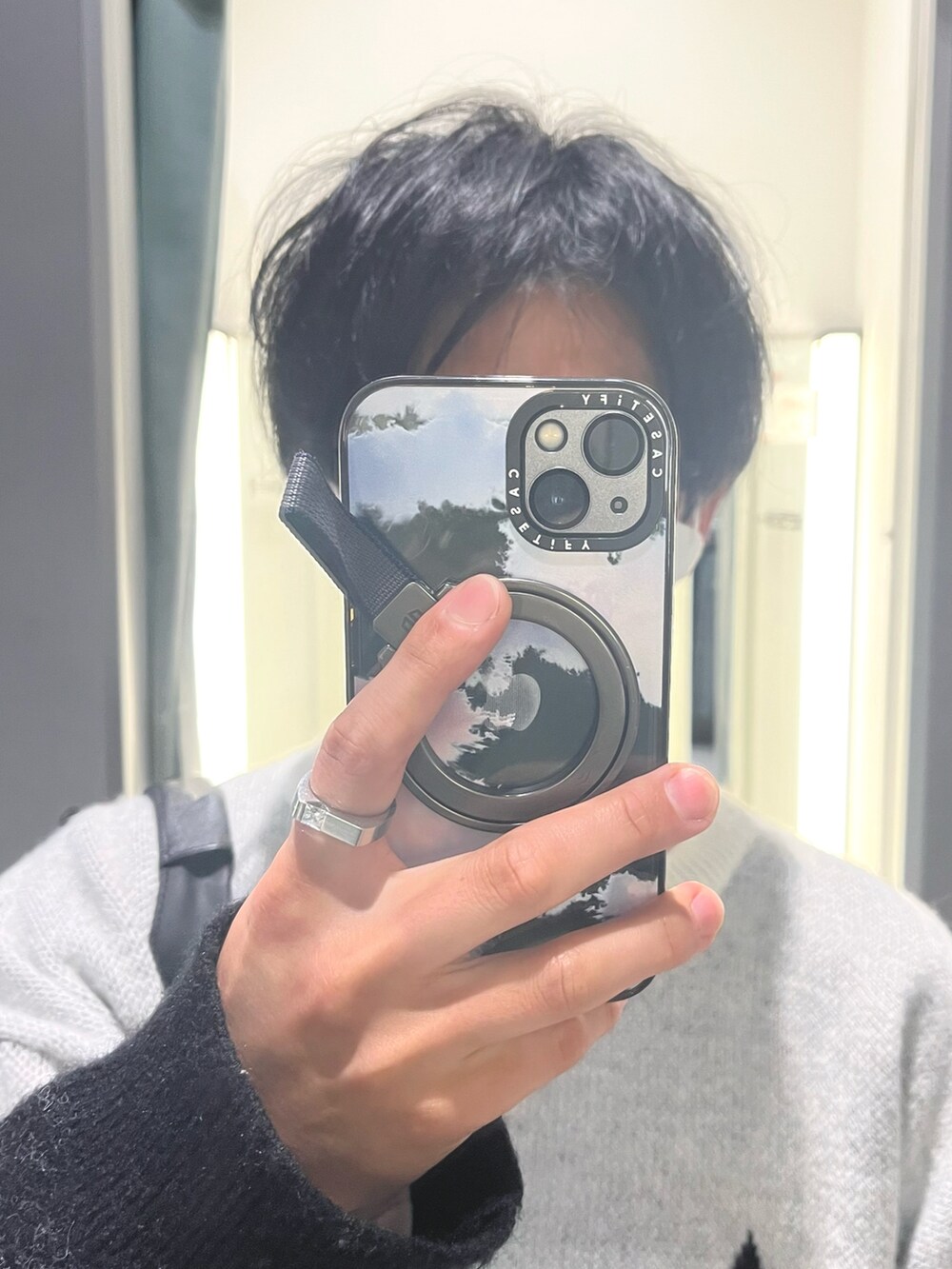 ブラック系のパンツ、ブラック系のドレスシューズ、ホワイト系のニット/セーターを着用したメンズの冬コーディネートの4枚目の写真
