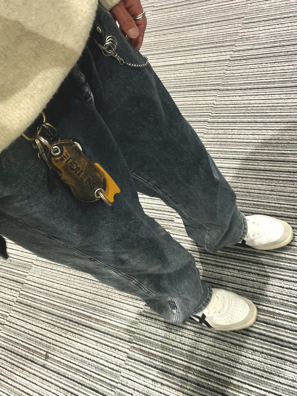 グレー系のデニムパンツ、ホワイト系のスニーカー、ホワイト系のニット/セーターを着用したメンズの春コーディネートの3枚目の写真