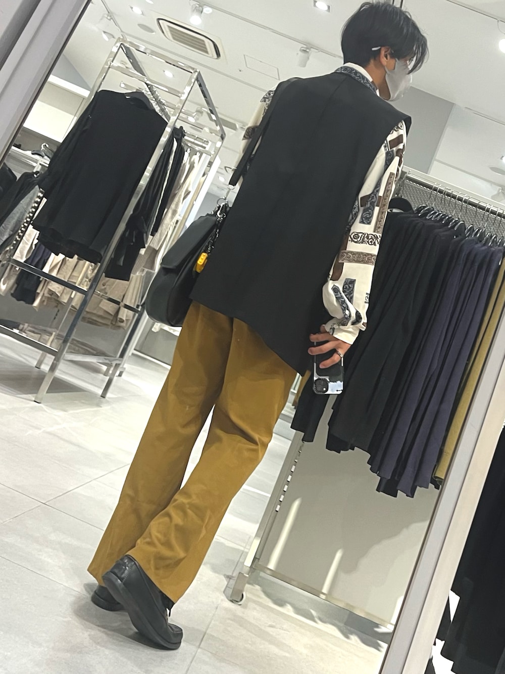 ブラック系のローファー、オレンジ系のパンツ、ホワイト系のシャツ/ブラウスを着用したメンズの秋コーディネートの2枚目の写真