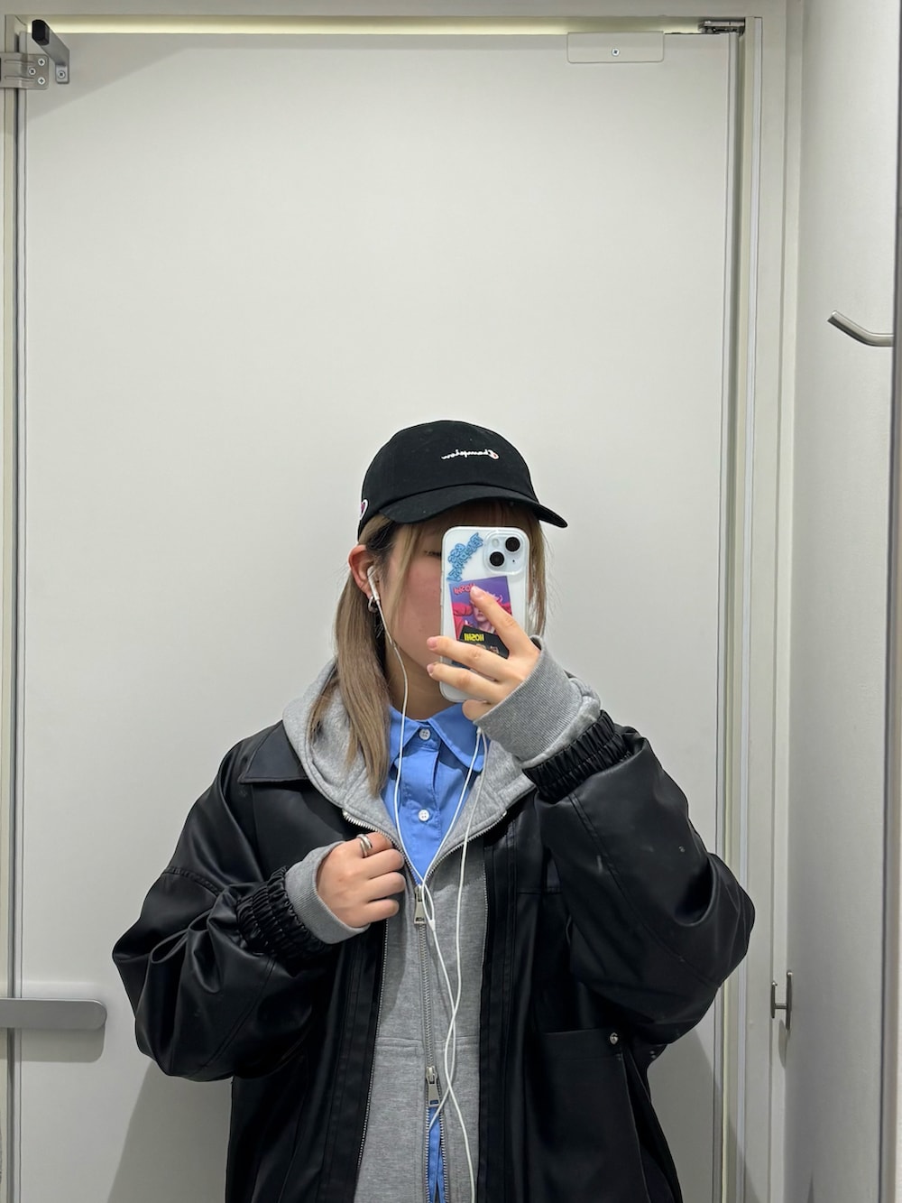 ブラック系のブルゾン、シルバー系のハンドバッグ、グレー系のスウェットパンツを着用したレディースの冬コーディネートの5枚目の写真