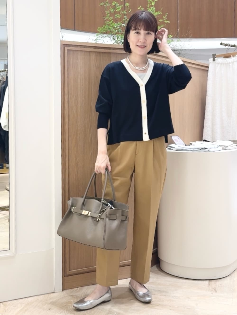 ブルー系のカーディガン/ボレロ、イエロー系のその他パンツ、ベージュ系のトートバッグを着用したレディースの秋コーディネートの7枚目の写真