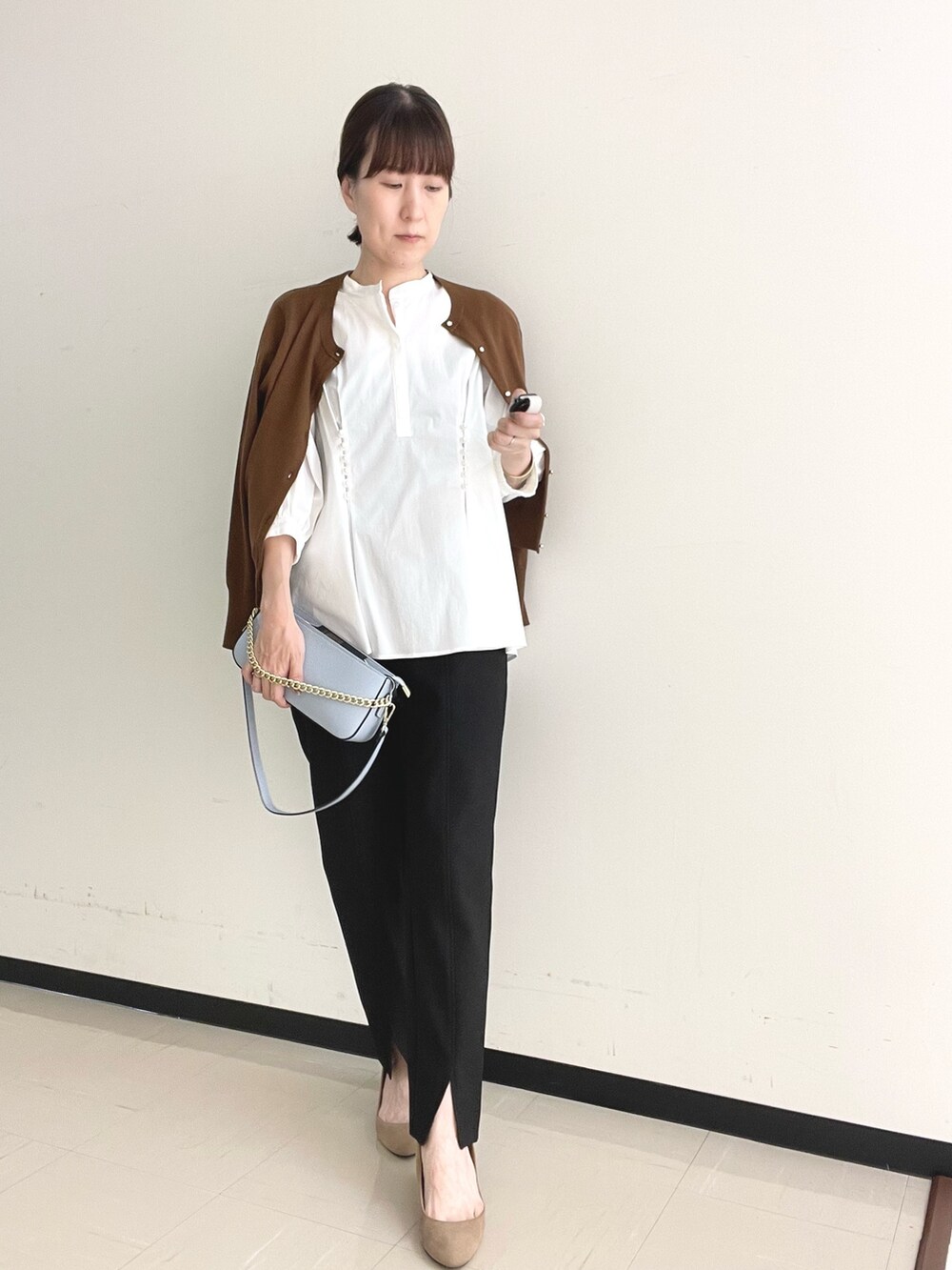 ブラック系のその他パンツ、ブルー系のショルダーバッグ、ホワイト系のシャツ/ブラウスを着用したレディースの秋コーディネートの5枚目の写真