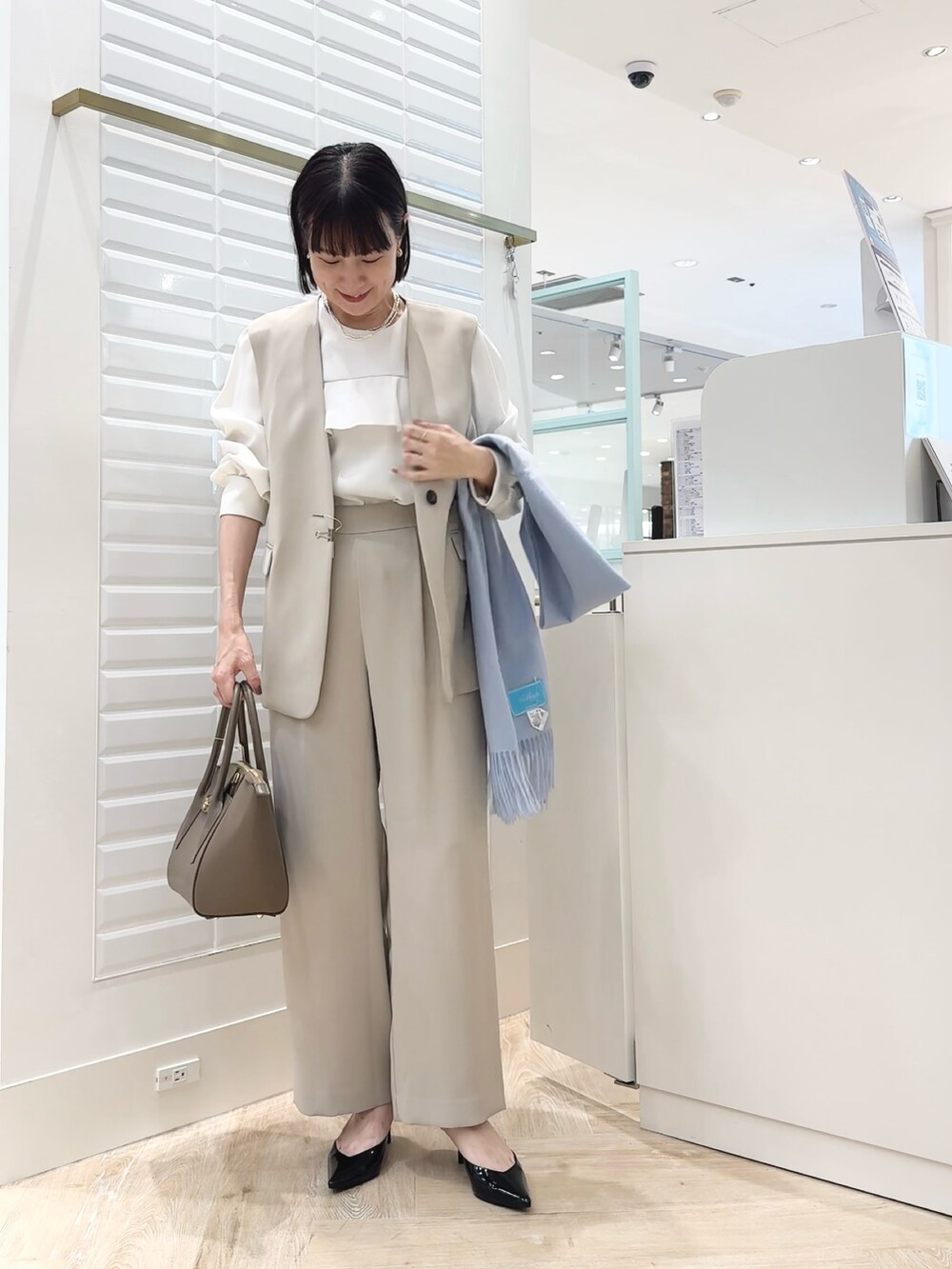 ブラウン系のショルダーバッグ、ベージュ系のその他パンツ、ベージュ系のベストを着用したレディースの秋コーディネートの8枚目の写真