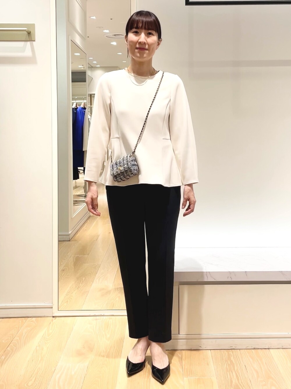 ホワイト系のその他パンツ、ホワイト系のTシャツ/カットソー、ブラック系のショルダーバッグを着用したレディースの冬コーディネートの2枚目の写真