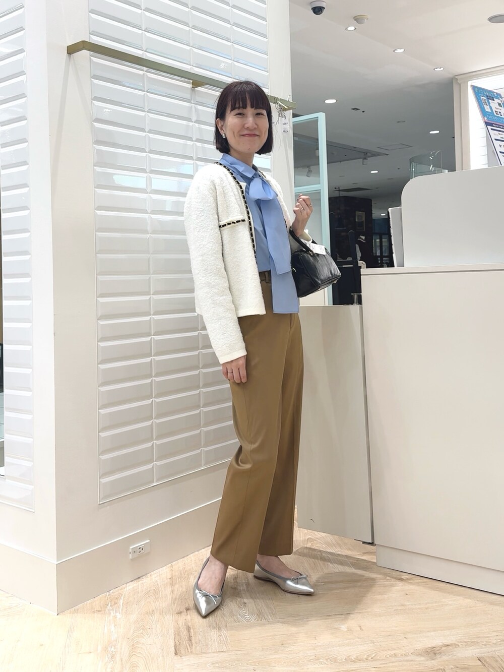 ブルー系のシャツ/ブラウス、ブラック系のボストンバッグ、イエロー系のその他パンツを着用したレディースの秋コーディネートの7枚目の写真