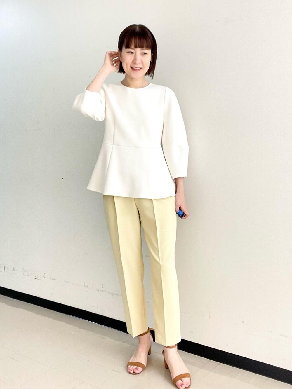 イエロー系のその他パンツ、ホワイト系のTシャツ/カットソー、ゴールド系のイヤーカフを着用したレディースの冬コーディネートの5枚目の写真