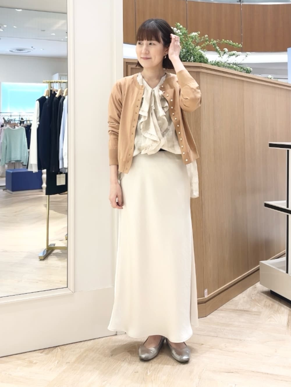 イエロー系のカーディガン/ボレロ、ホワイト系のシャツ/ブラウス、ベージュ系のショルダーバッグを着用したレディースの春コーディネートの6枚目の写真