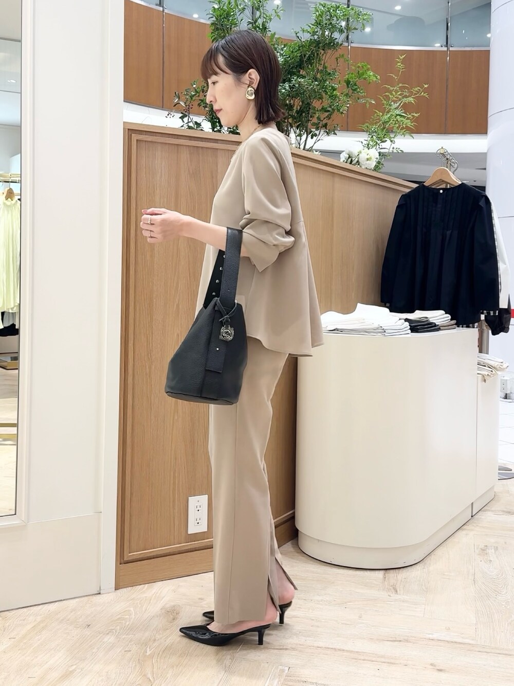 ブラック系のショルダーバッグ、ベージュ系のその他パンツ、ベージュ系のシャツ/ブラウスを着用したレディースの秋コーディネートの2枚目の写真