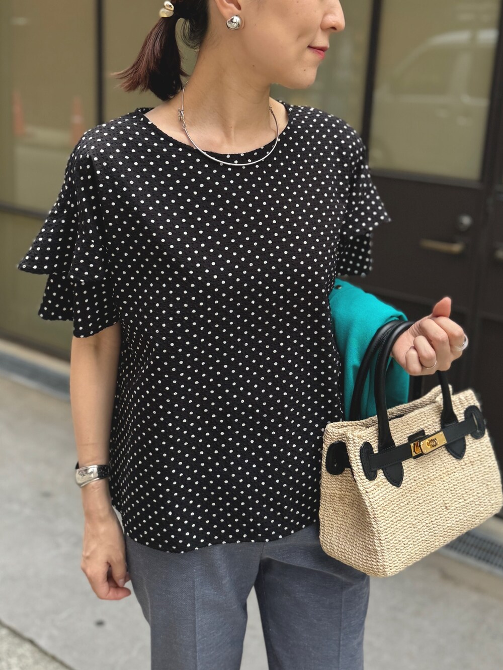 ゴールド系のサンダル、ブルー系のその他パンツ、ブラック系のかごバッグを着用したレディースの春コーディネートの9枚目の写真