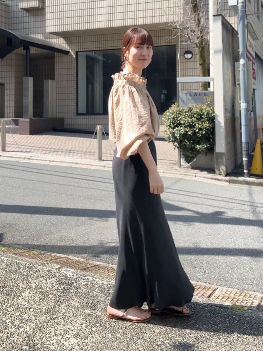 ブラック系のスカート、イエロー系のシャツ/ブラウス、その他のネックレスを着用したレディースの春コーディネートの5枚目の写真